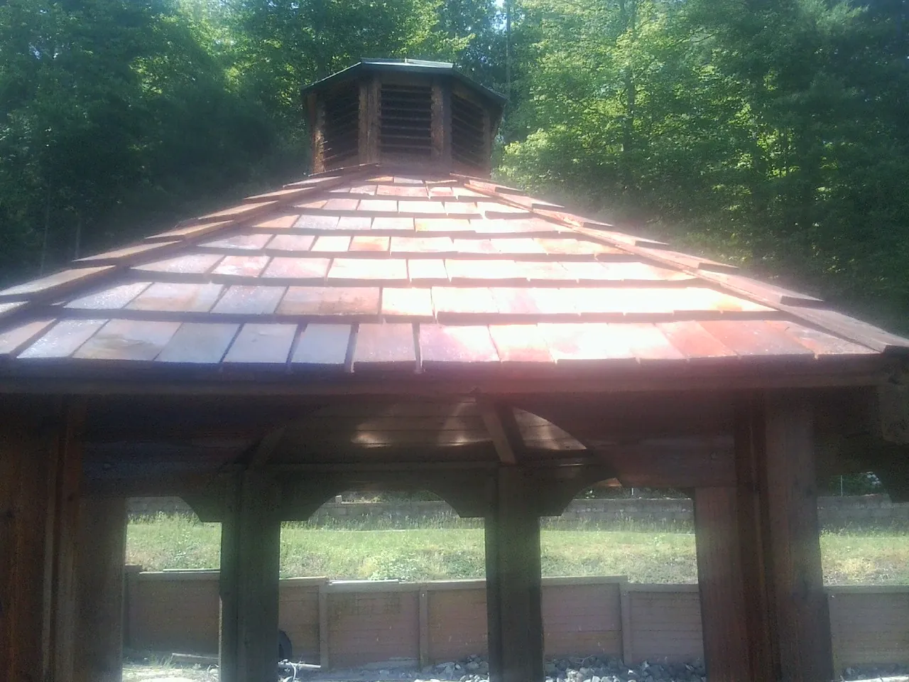 New cedar shake roof and cupola on a lakeside gazebo in Mystic